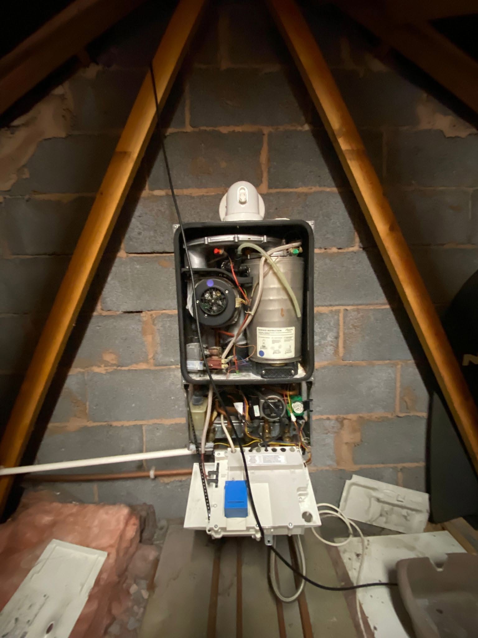 A loft boiler with its casing off during work