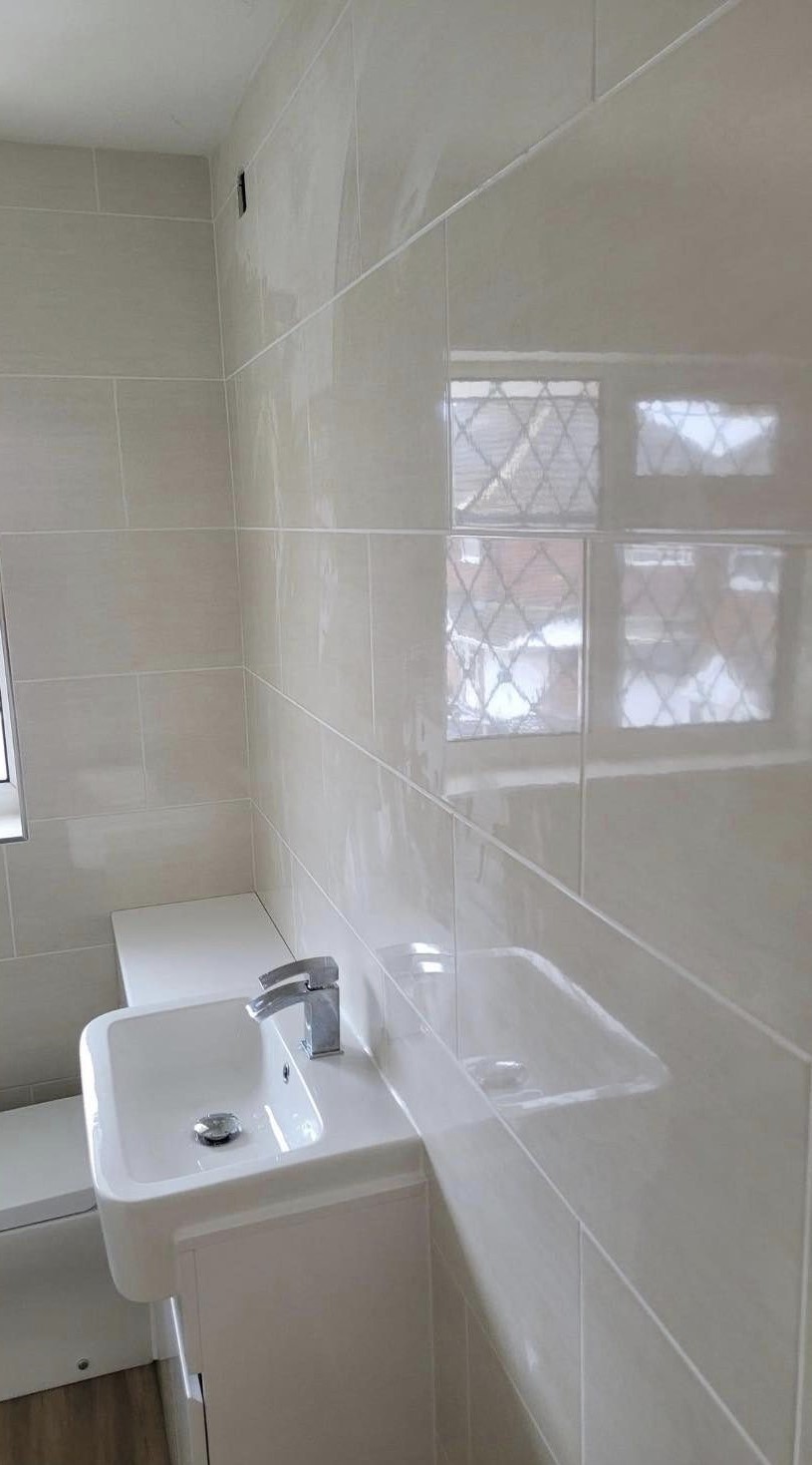 A new vanity basin beside a leaded window