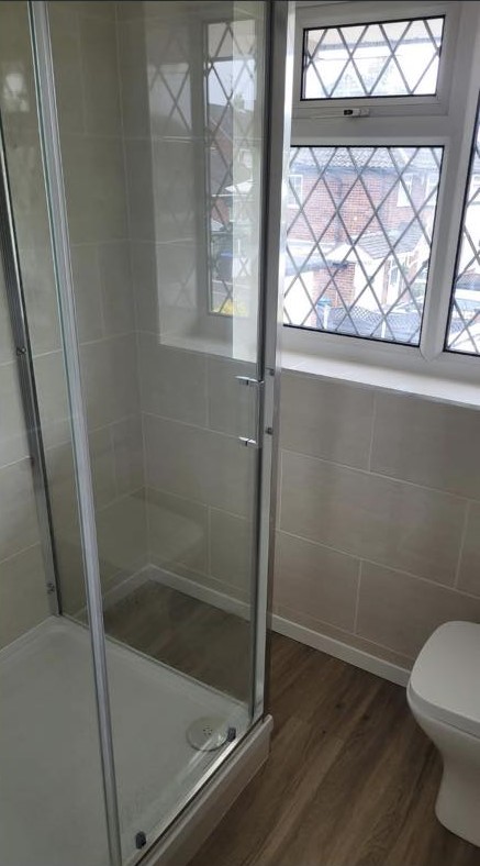 A shower enclosure and WC by a leaded window
