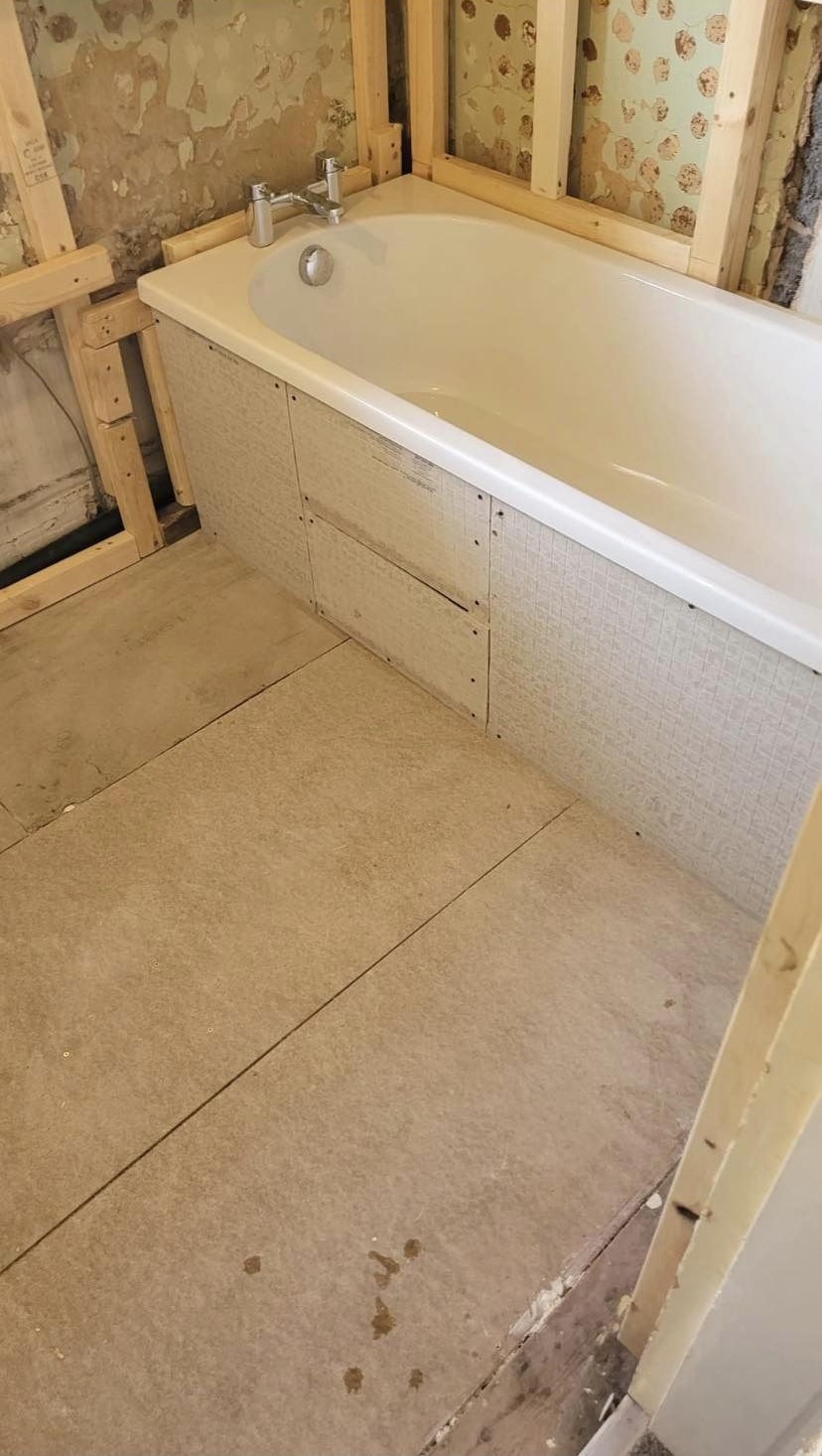The bath panel and floor boarded, ready for tiling
