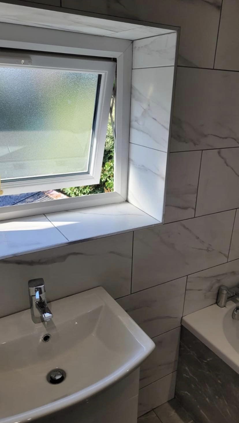 A new basin under a tiled window reveal
